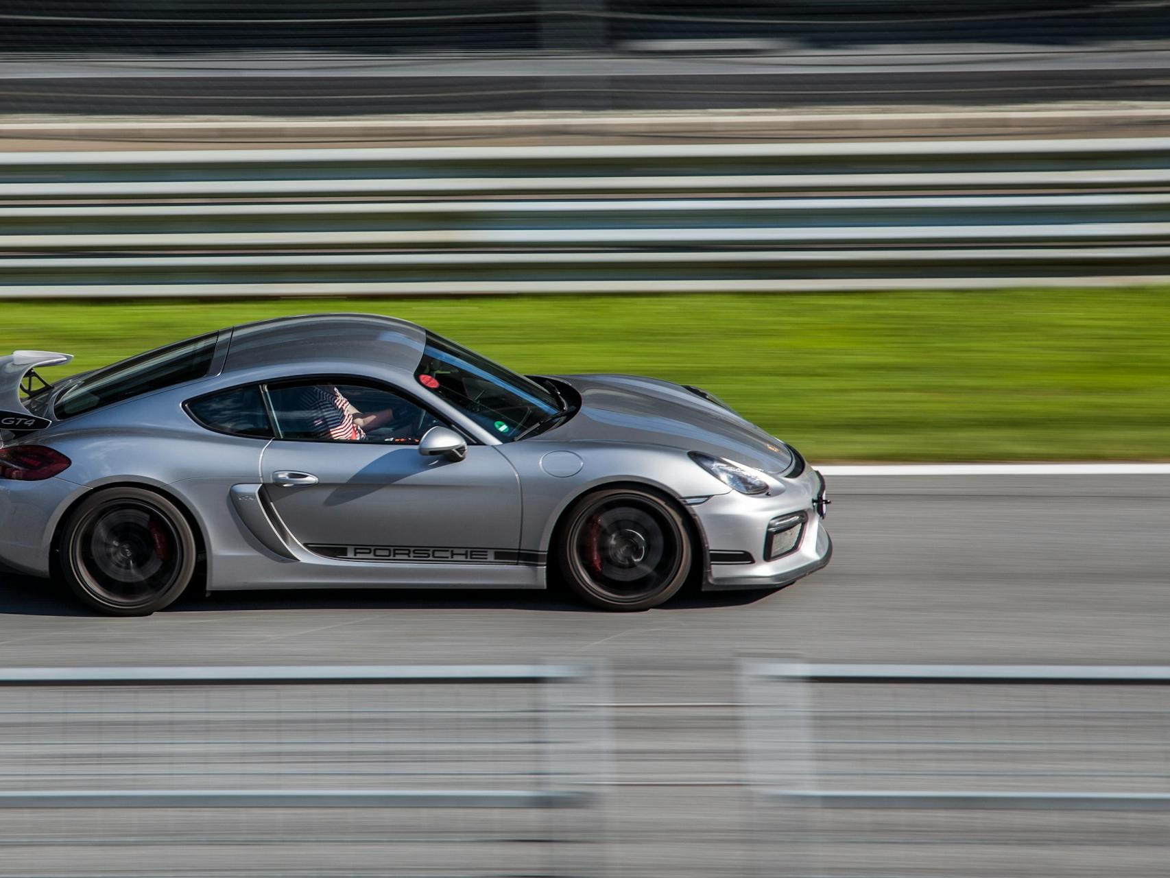 gray sports coupe on road at daytime